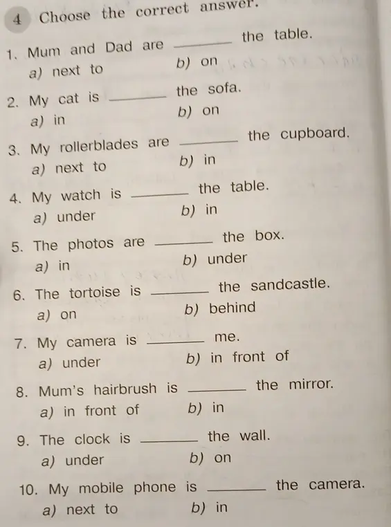 Выбери правильный ответ в предложении 'Mum and Dad are ... the table.'
