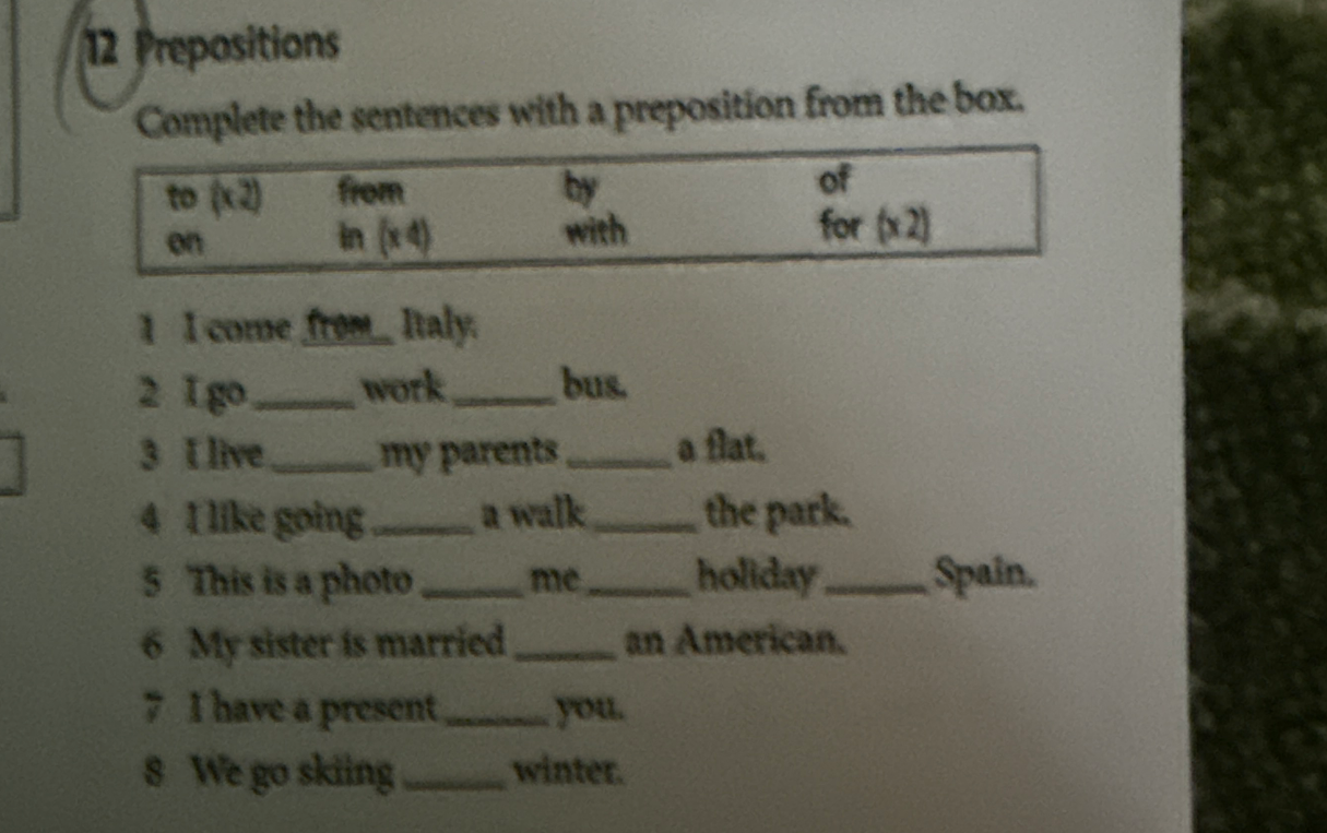 Complete the sentences with a preposition from the box.